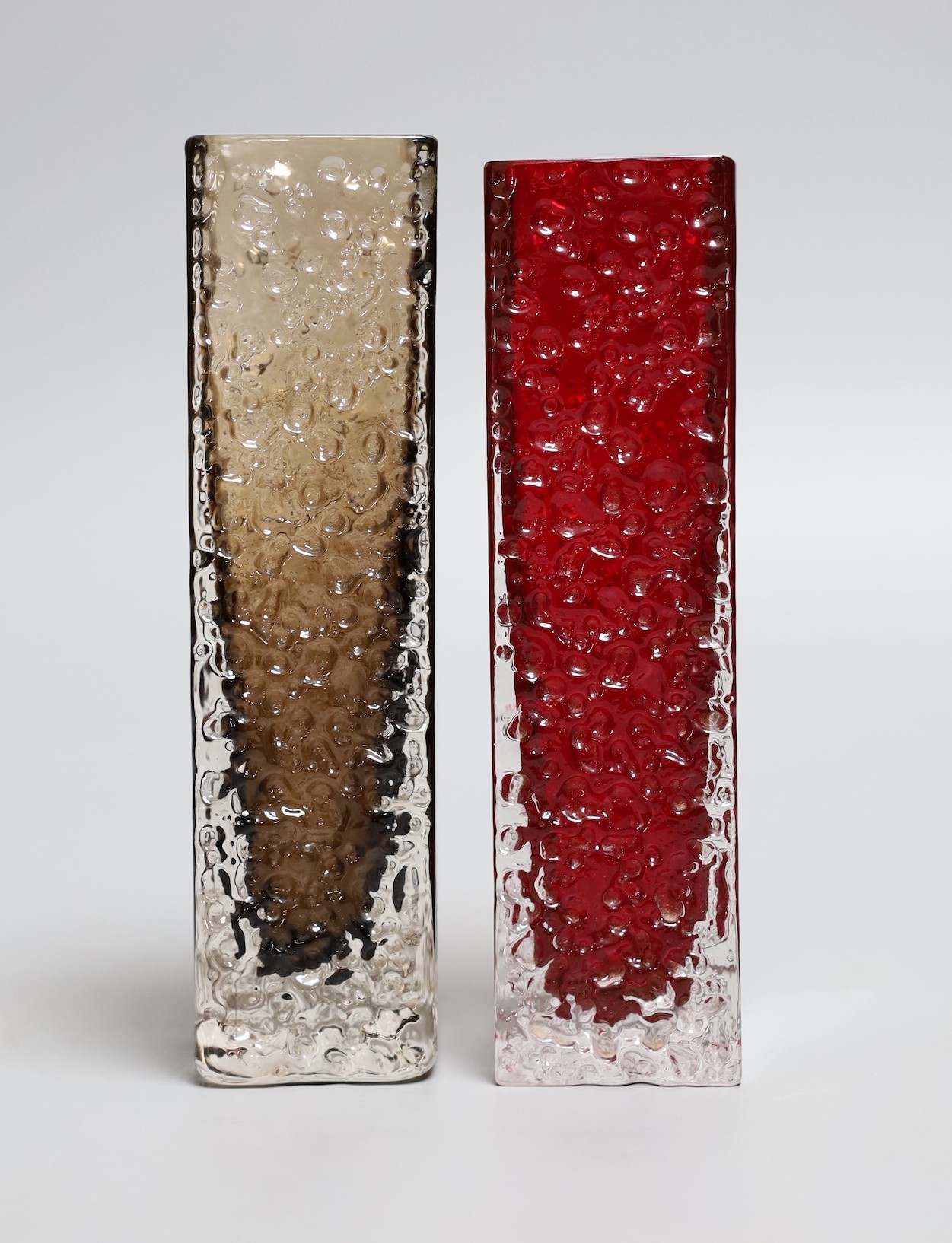 Two Whitefriars red 'Nailhead' vases, model 9683, designed by Geoffrey Baxter, each 17cm high.